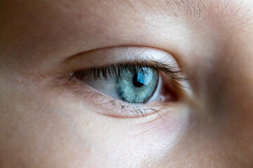 Fototapeta na wymiar Beautiful blue woman single eye close up.