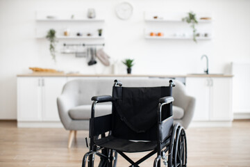 Empty wheelchair in the kitchen. Lonely and healthcare concept.