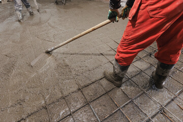 Construction site of buildings pouring cement. Top view new screed concrete with leveling mortar...