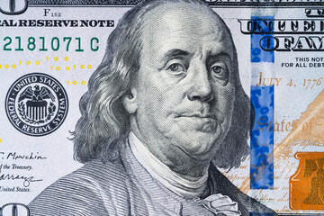 Macro shot of a brand new one hundred dollar bill showing the face of Benjamin Franklin.