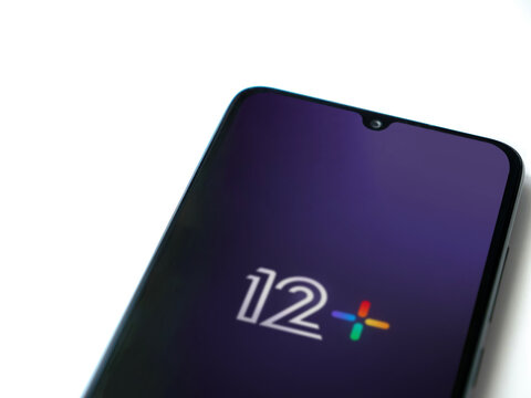 Lod, Israel - July 16,2023: 12+ app launch screen on smartphone on white background. Top view flat lay with copy space.