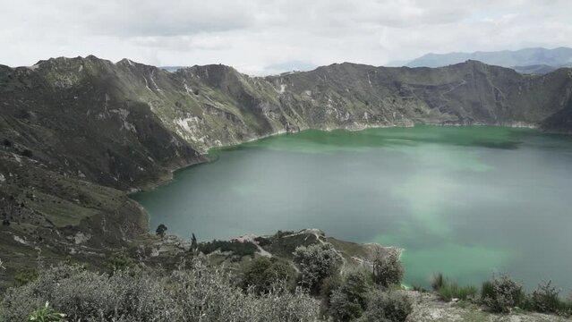 aerial of laguna quilotoa at the quilotoa loop in the andes mountains of Ecuador, is an emerald green lake in a caldera of an old volcano cater and a popular travel destination for hikers.