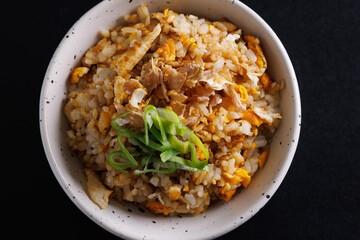 Japanese fried rice yakimeshi isolated in black background