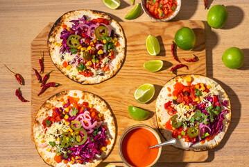Preparation of   testy vegan Tacos, plant based diet,  with black beans, corn, jalopeno peppers, red cabbage, salsa, coriander leaves and marinated onion. Mexican tradition recipes. Top view - obrazy, fototapety, plakaty