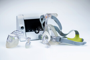 Continuous positive airway pressure system includes of CPAP machine, mask, tube on white background.