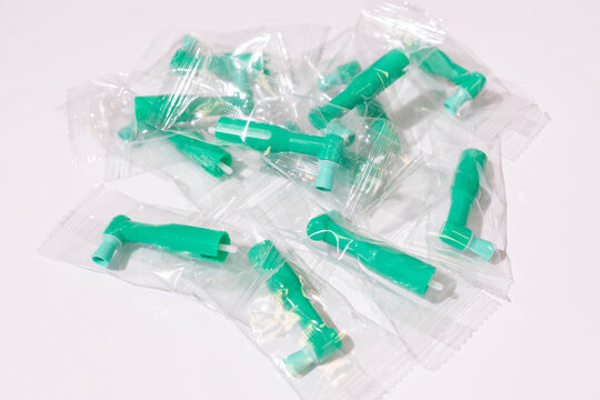 Top View Green Disposable Prophy Angles with Brush, Ergonomic Shape on White Background. Dentistry, Orthodontic Product. Oral Hygiene. Horizontal Plane 