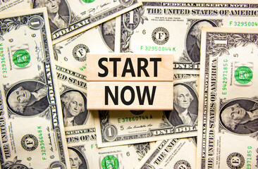 Start now symbol. Concept words Start now on beautiful wooden block. Beautiful background from...