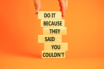 You can do it symbol. Concept words Do it because they said you could not on wooden block. Beautiful orange table background. Businessman hand. Business, motivational you can do it concept. Copy space