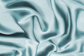 Blue silk or satin luxury fabric texture. Top view.