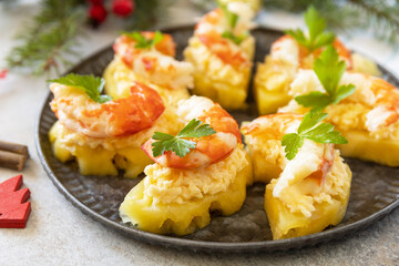 Christmas appetizers. Shrimp on pineapple with cheese filling on the festive table.