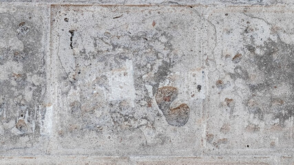 Texture of a gray concrete wall with traces of dismantled facing tiles