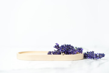 Cosmetics and skin care product presentation scene made with lavender flowers and tray.