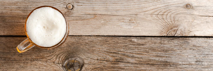 Beer glass on an old wooden table.