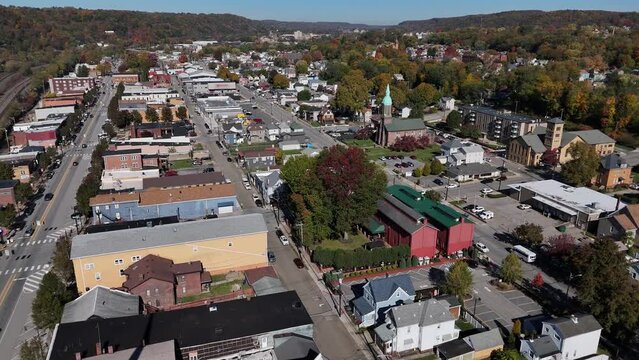 A high angle wide aerial establishing shot of a small New England town's business district. Pittsburgh suburbs.  	