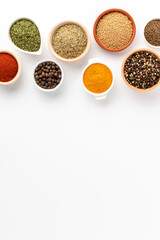 Overhead shot of seasonings in bowls isolated on white background with copyspace