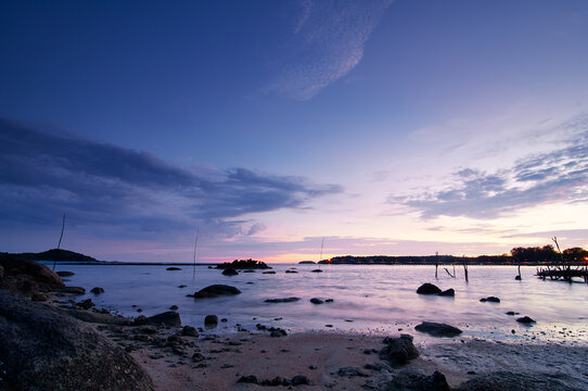 Beautiful seascape with colorful sky. Sunset and night time on the rock beach. © luengo_ua