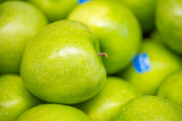 background of green apples in the store