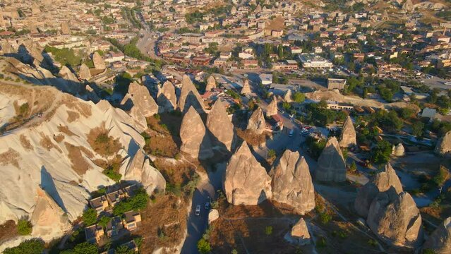 Embark on a mesmerizing journey to the enchanting city of G reme, Turkey, with this captivating aerial stock video. Marvel at the unique, otherworldly landscape where ancient inhabitants once carved