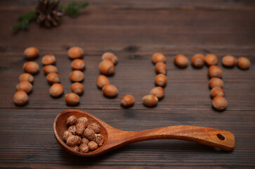 peeled hazelnut kernels in a wooden spoon close-up