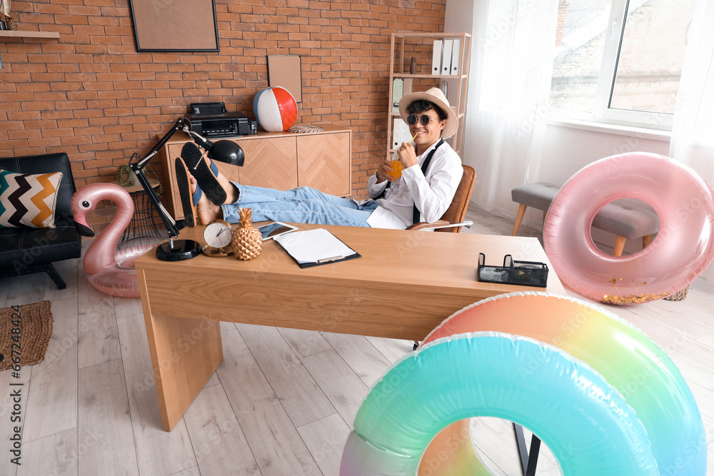 Canvas Prints Young businessman with cocktail ready for summer vacation in office