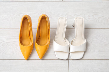 Stylish high heeled shoes on floor