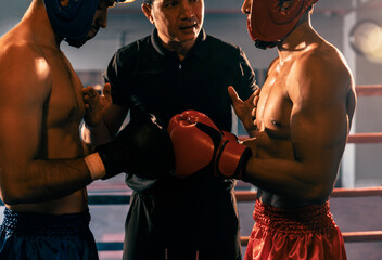 Boxer fighter with safety helmet or head guard face off with each other while referee explain rules...