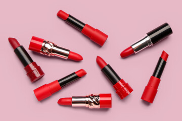 Different new bright lipsticks on pink background