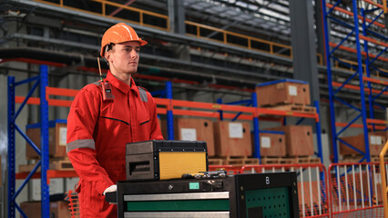 Young railway engineer  wearing  red safety uniform works in factory, railway transportation system