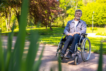 Fototapeta premium A man on a wheelchair looking contented and confident