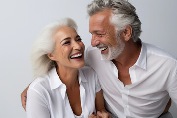 Studio shot of senior couple posing against a grey background