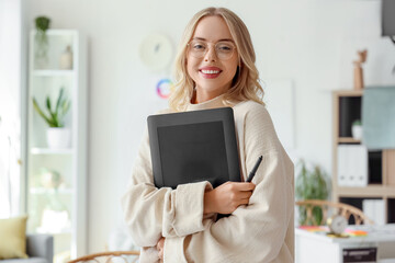 Female interior designer with graphic tablet in office