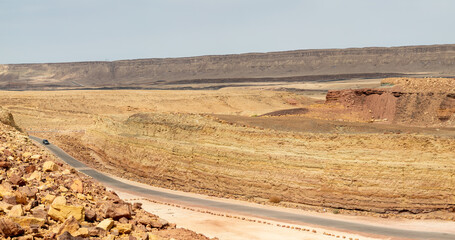 Road through Makhtesh Ramon, erosion crater landscape panorama, Negev desert, Israel - obrazy, fototapety, plakaty