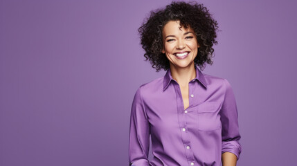 Obraz na płótnie Canvas Confident mature woman with crossed arms in casual clothing with copy space. Successful smiling woman with big grin looking at camera. Beautiful positive businesswoman standing against purple