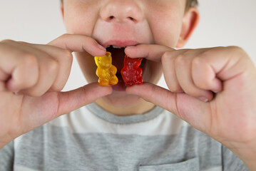 boy eating gummy bears, close-up.