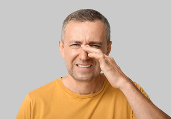 Fototapeta premium Ill mature man on grey background