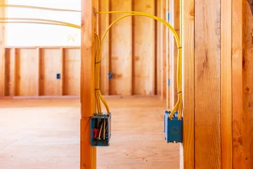 New Home construction with wood and electrical wiring boxes © Kelly Headrick
