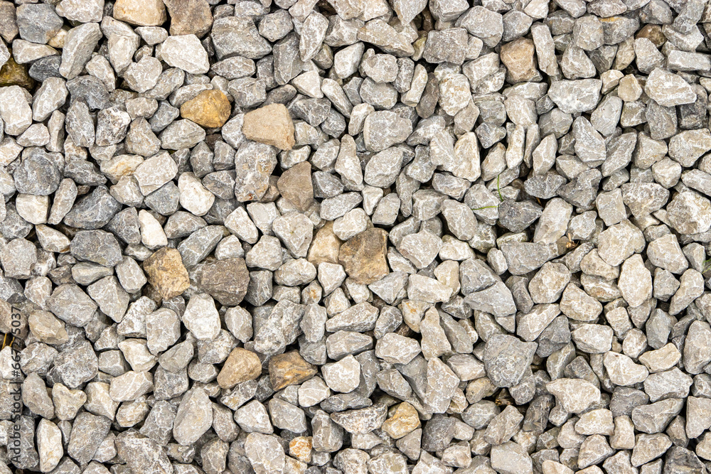 Poster shallow focus on small gravel, creating a unique road texture pattern.