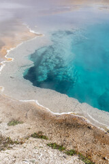 Brilliant blue thermal pool in West Thumb Basin in Yellowstone National park