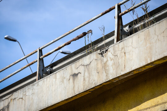 Cracks in the concrete structure of a bridge in a state of decay