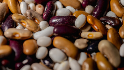 Legumes (beans). Background of many grains of dried beans. brown beans texture. Food background. close Background of beans and textured. Background of colored beans