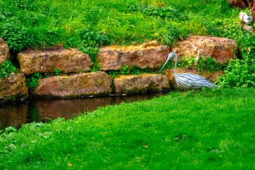 Metal bird sculpture by river