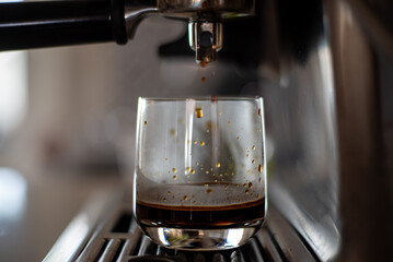 Espresso dripping into a glass