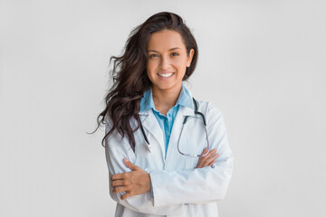 Fototapeta na wymiar Confident female doctor with stethoscope, arms crossed