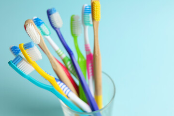 Different toothbrushes on a colored background. Dental care, oral health.