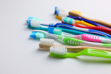Different toothbrushes on a colored background. Dental care, oral health.