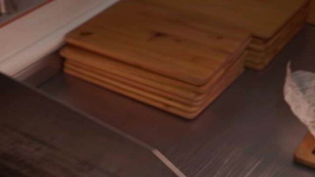 Chef in black gloves making burge. Close-up of a skilled craftsman working at the workplace with burger bun