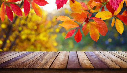 Naklejka na ściany i meble wooden table and blurred autumn background autumn concept with red yellow leaves background