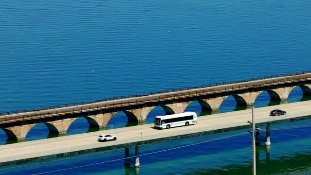 Aerial stock video metro bus driving on the seven mile bridge Florida Keys