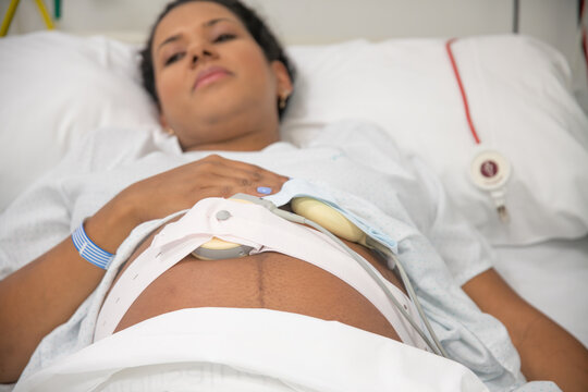 Close-up of expectant mother with fetal heart rate monitor