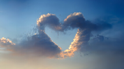 Clear blue sky with heart shaped cloud